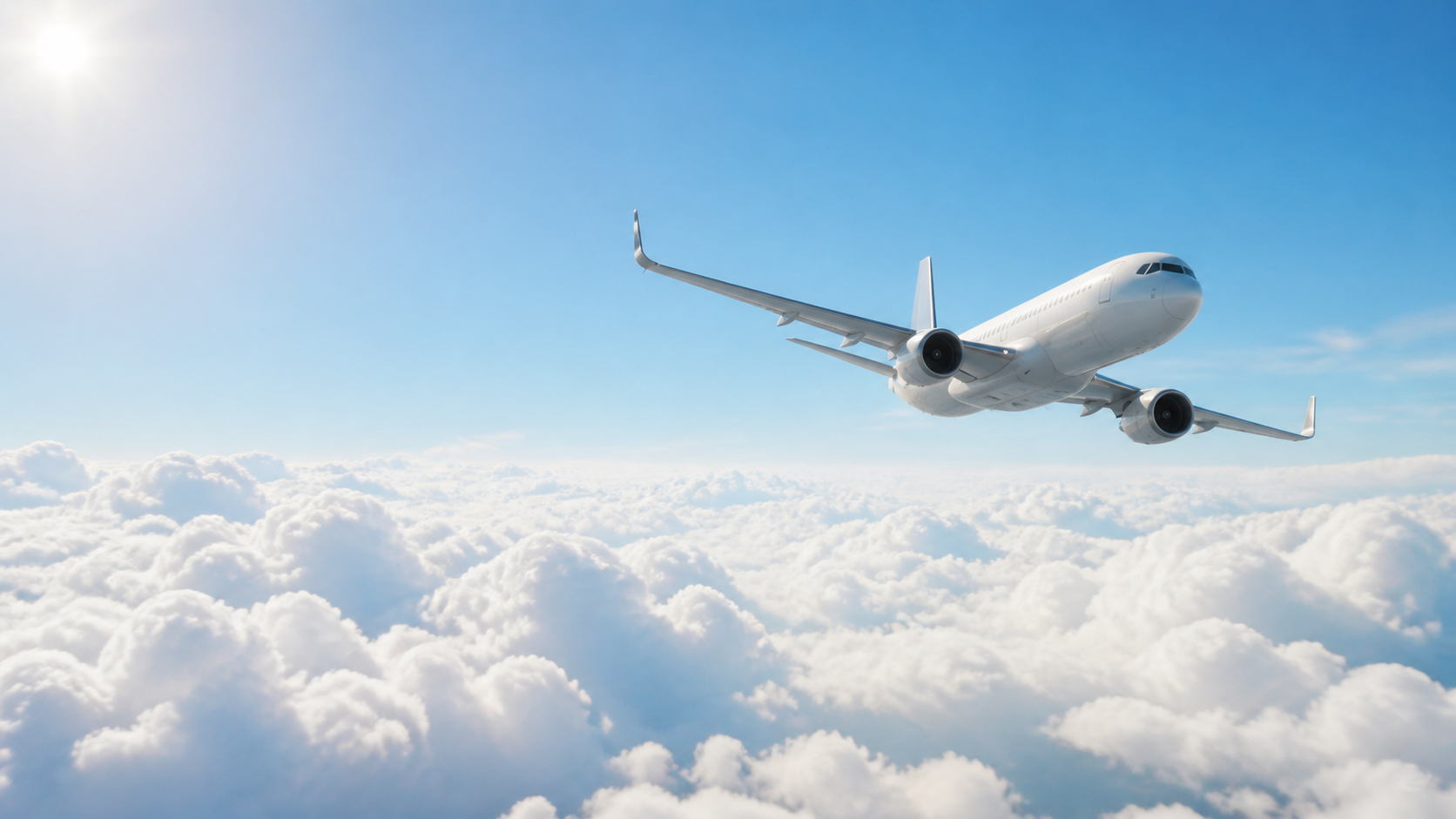 An airplane flying high above the clouds in a bright morning sky